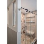 tiled shower with interior windows and rolling glass barn door