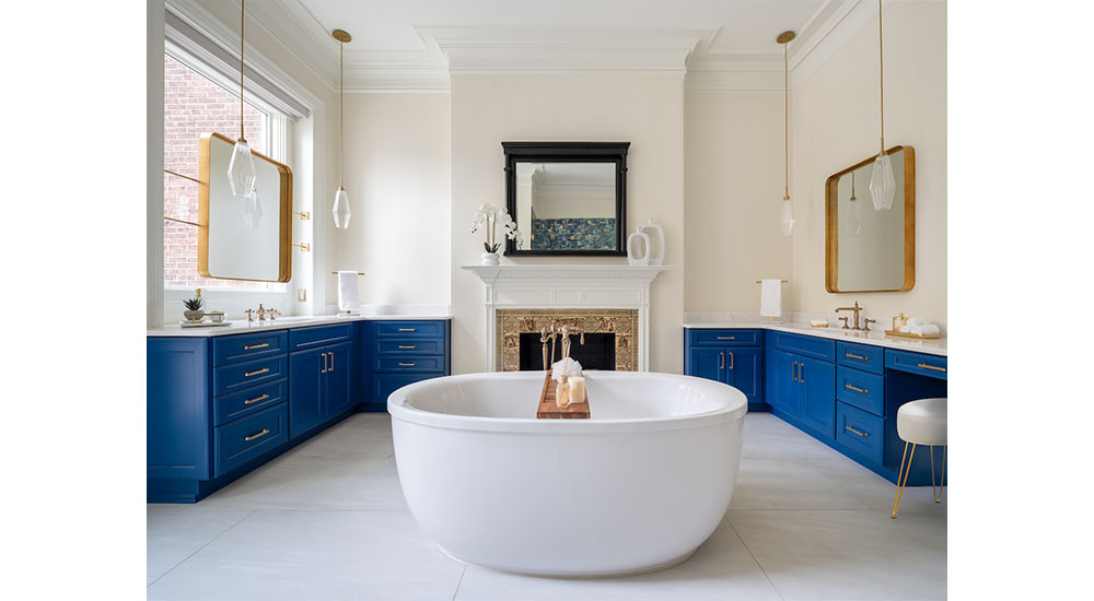 freestanding tub in bathroom with historic tiled fireplace