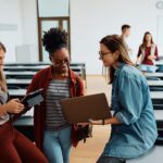 nkba students looking at laptops in classroom