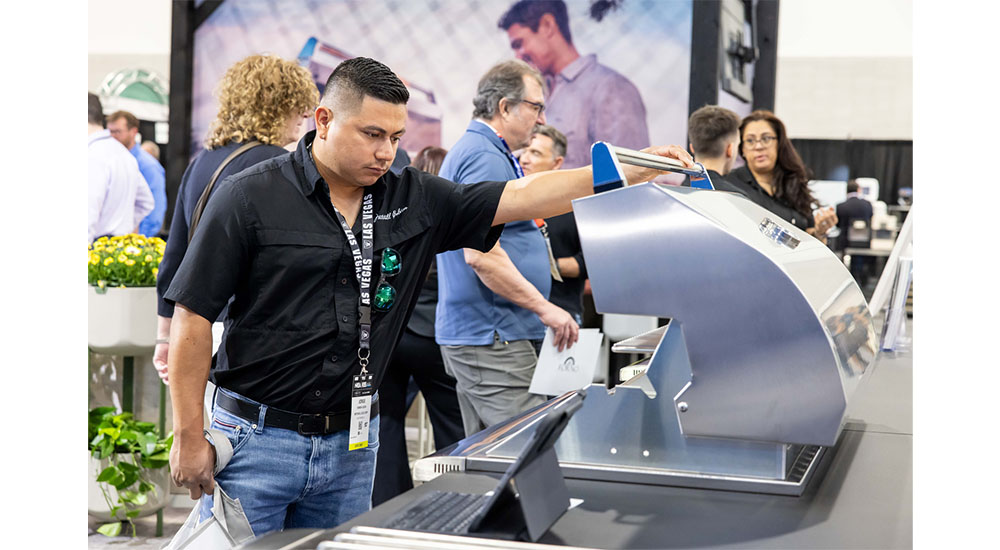 man looking at grill at kbis