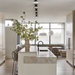 modern beach kitchen with island banquette and large window