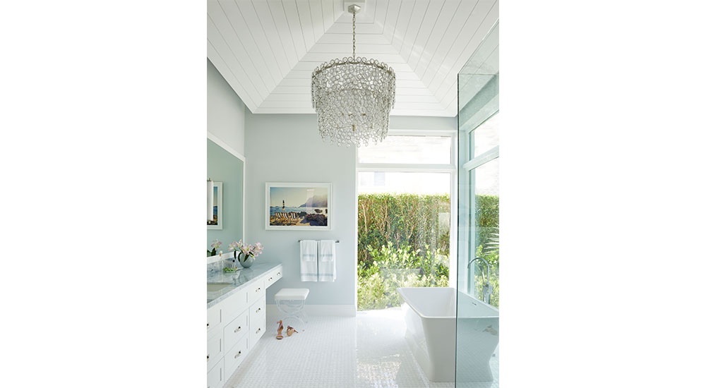 bathroom with high ceilings, chandelier and soaking tub