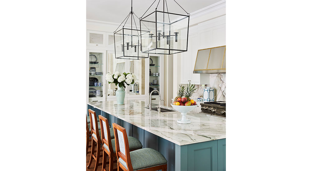 kitchen island with blue cabinets and white counter