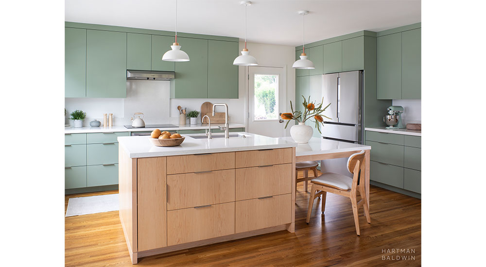 modern kitchen with green cabinets and island