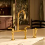 Brizo®_Faircroft™ Kitchen Collection_Deck Mount Bridge Kitchen Faucet with Side Spray with with Industrial Lever Handle_Unlacquered Brass (Patina)