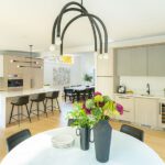 modern open plan kitchen with three cabinet finishes and beverage bar