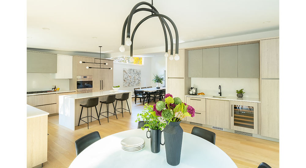modern open plan kitchen with three cabinet finishes and beverage bar