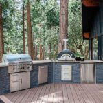 outdoor kitchen with grill, pizza oven and refrigerator