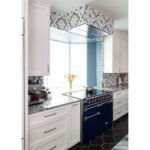 induction aga range and ceiling vent in windowed alcove finished in heritage tile