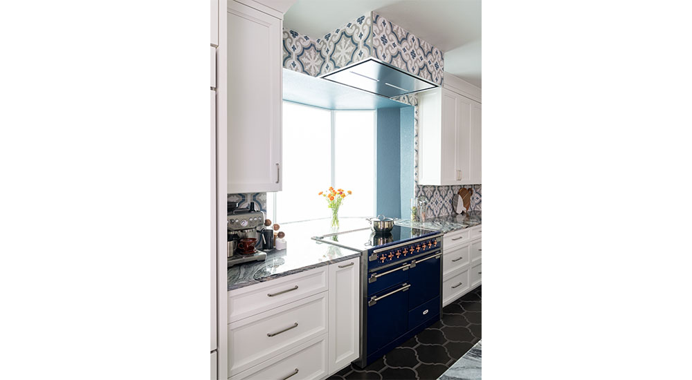 induction aga range and ceiling vent in windowed alcove finished in heritage tile