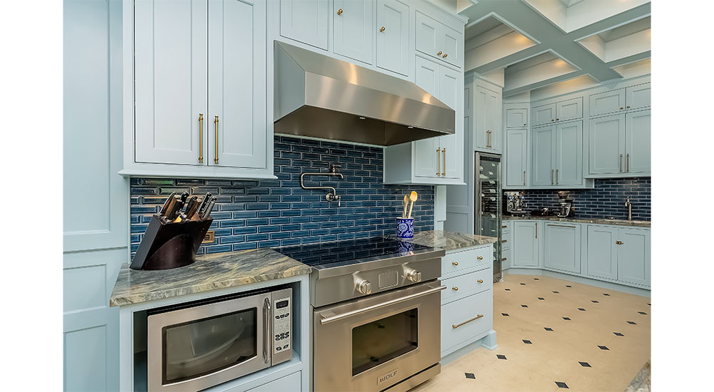 range microwave and wine refrigerator in historic blue kitchen