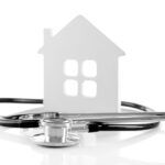 healthy home design stethoscope and paper house