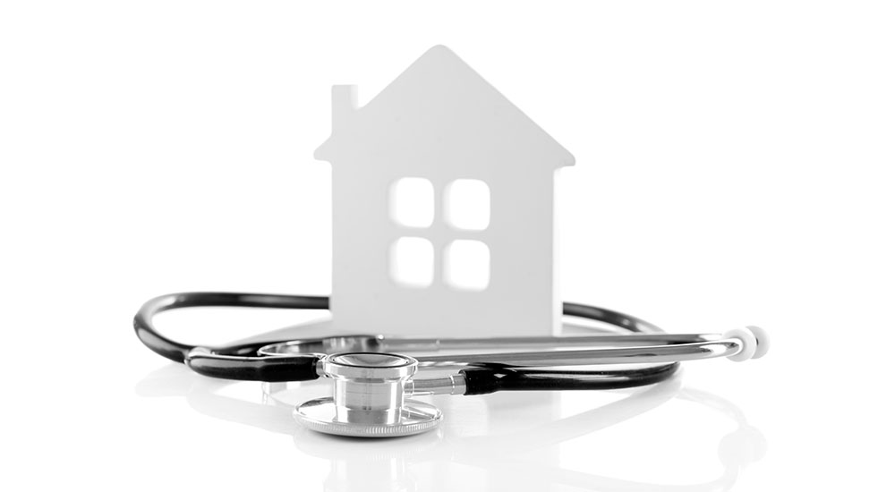 healthy home design stethoscope and paper house