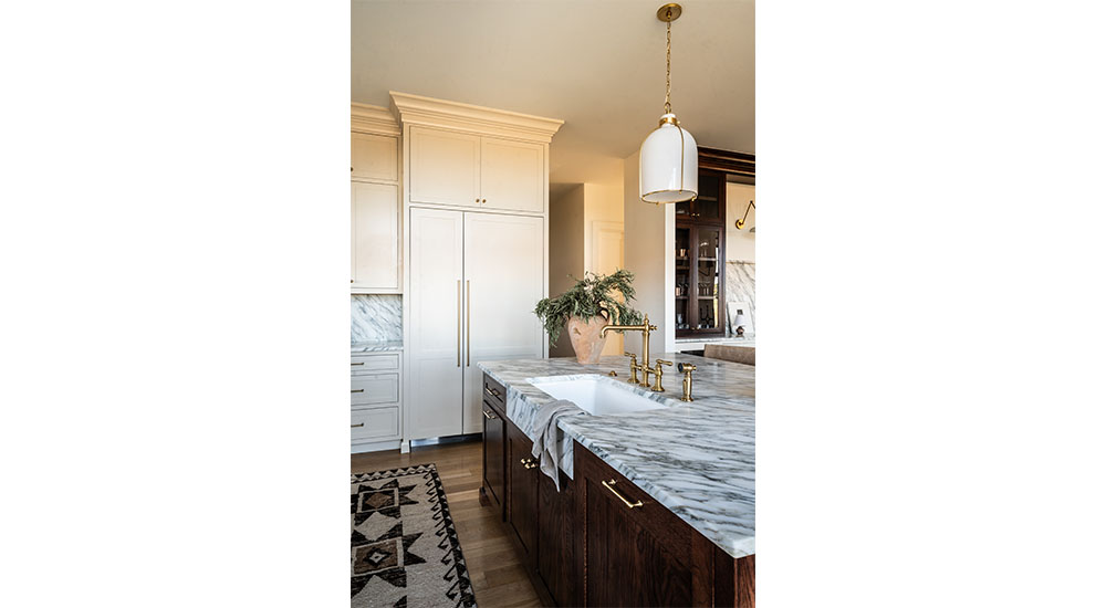 kitchen sink on island with marble counter in family kitchen