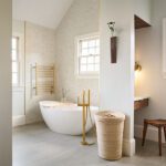 bathroom with freestanding tub and vanity niche