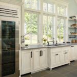 pool house kitchen with concrete counter and refrigerator