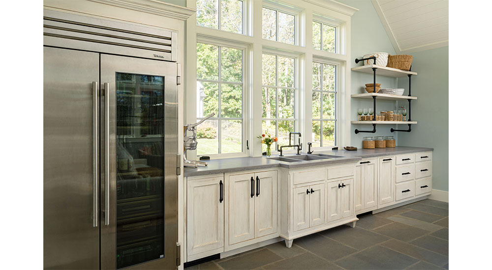 pool house kitchen with concrete counter and refrigerator