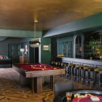 basement bar with pool table and gold ceiling