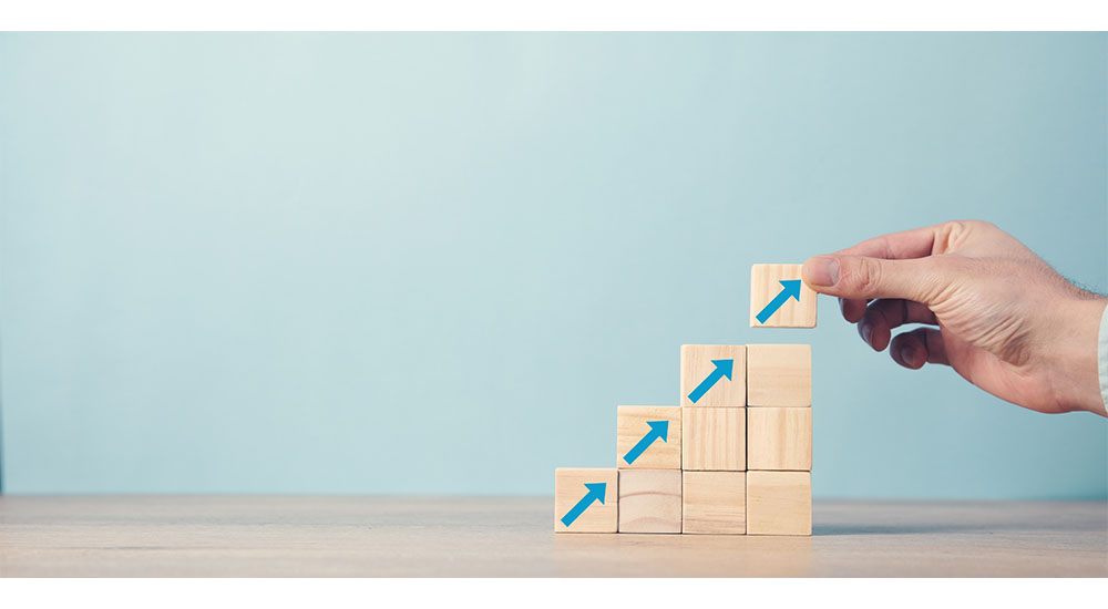 wooden tiles with upward arrows showing marketing for growth