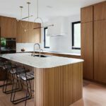 modern kitchen remodel with island wrapped in fluted wood